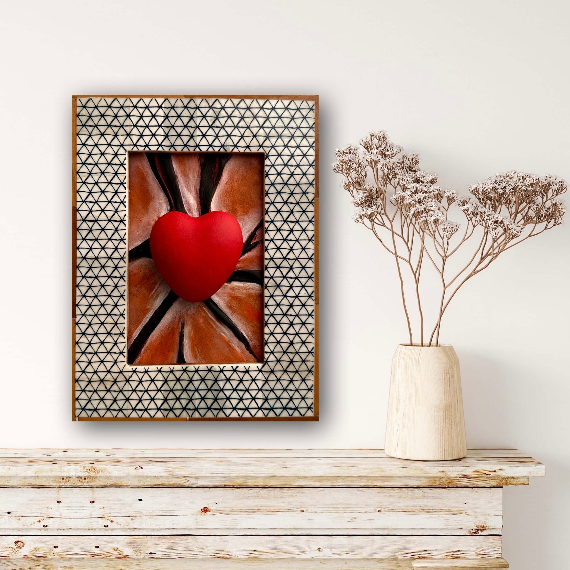 Artistic leather sculpture featuring intricate black lines in a black and wood-patterned frame.
