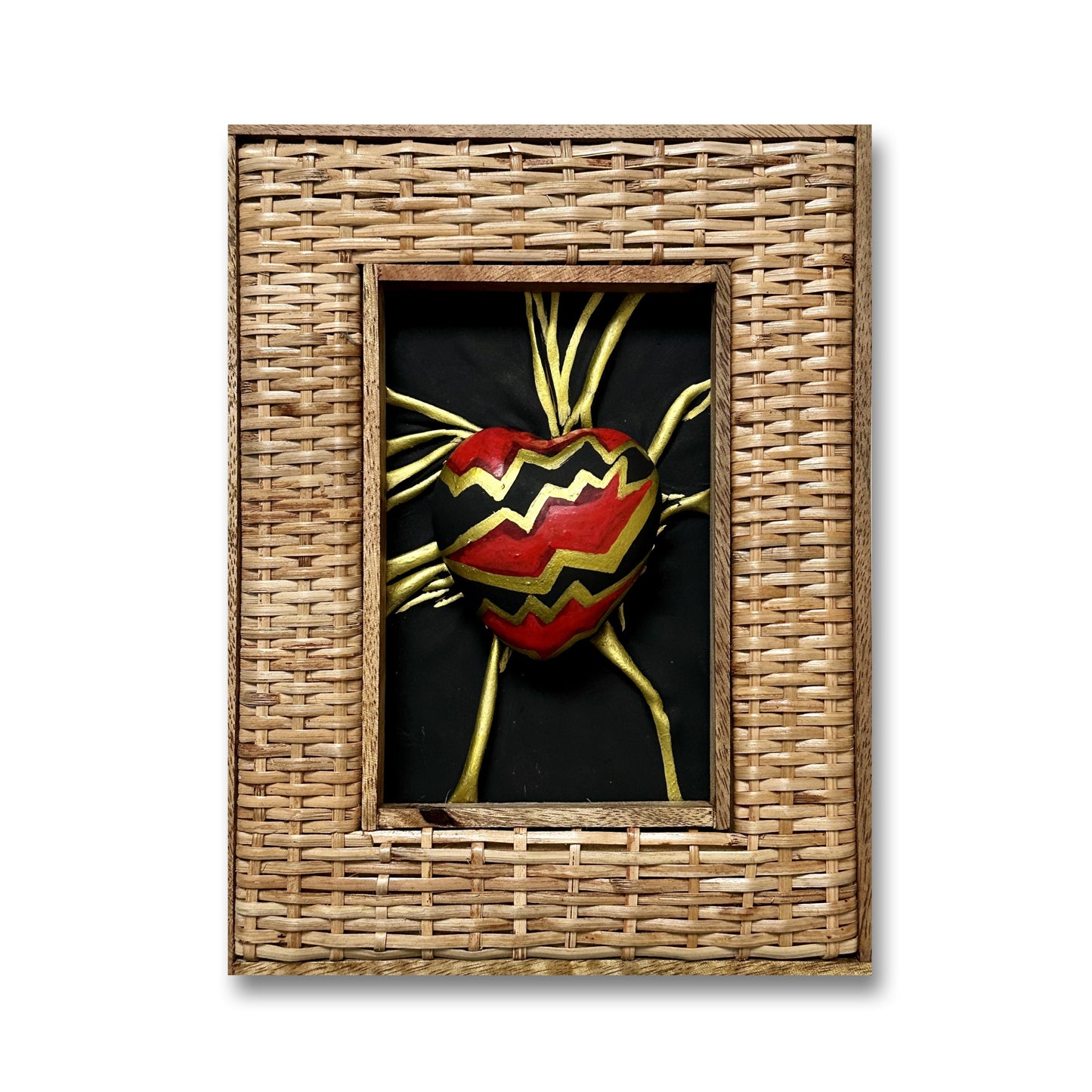 A hand-sculpted leather heart sculpture with black, red, and gold accents, displayed in a gold leaf-finished wooden frame.