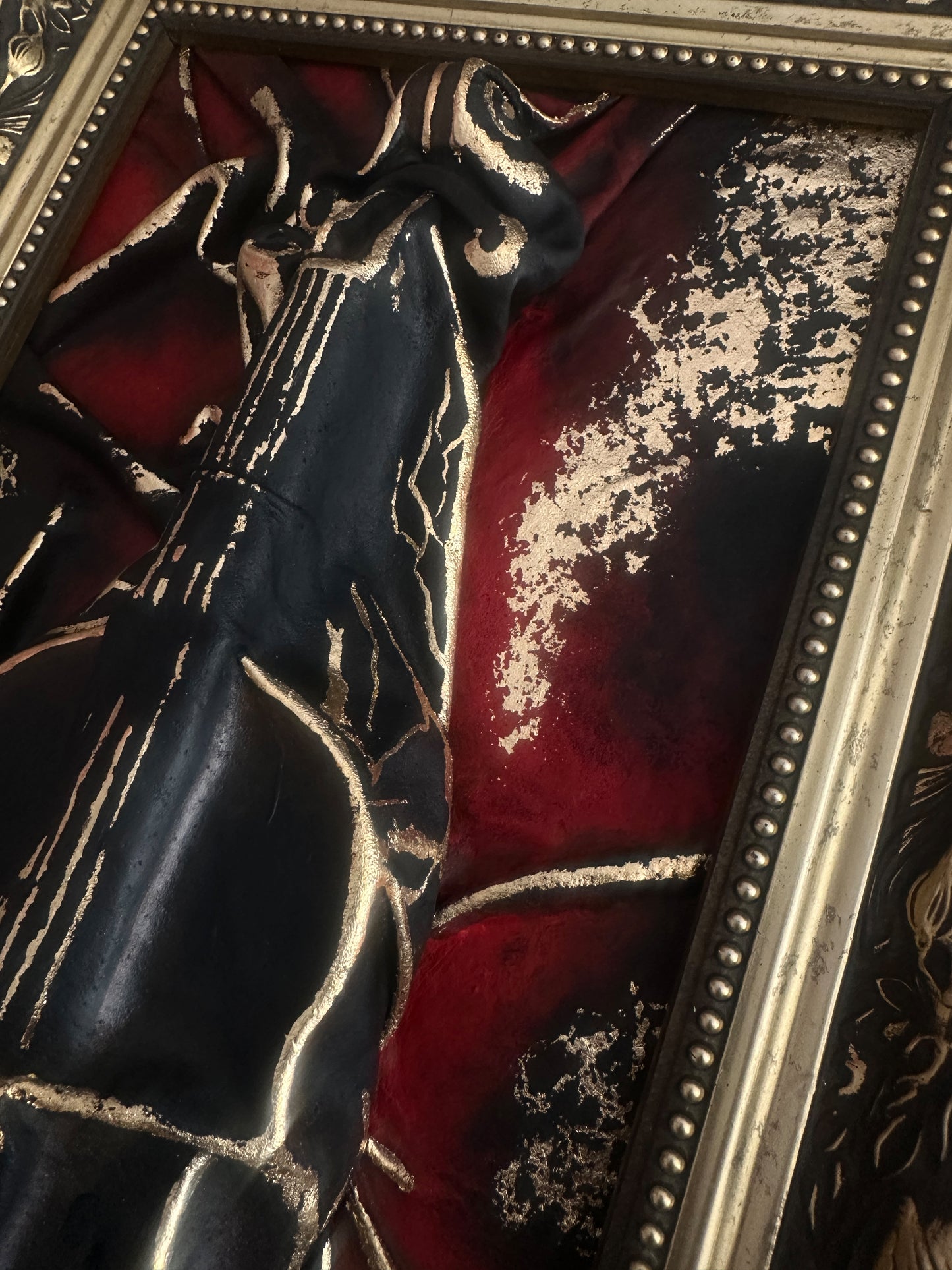 Framed three-dimensional violin sculpture in black and gold