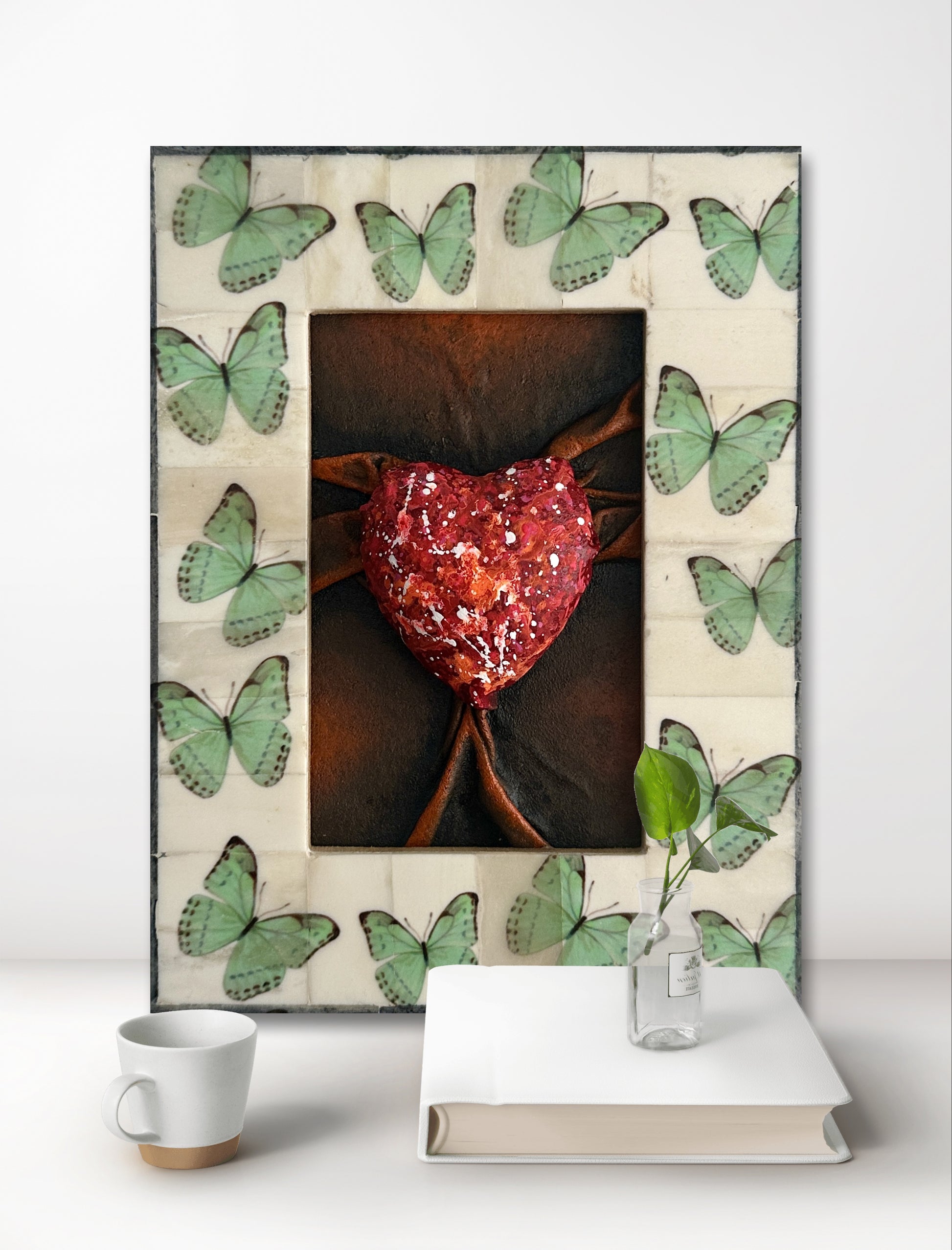 This captivating Lovers Heart Butterfly Dreams sculpture brings together red, black, and white tones in a symbolic expression of love and passion.