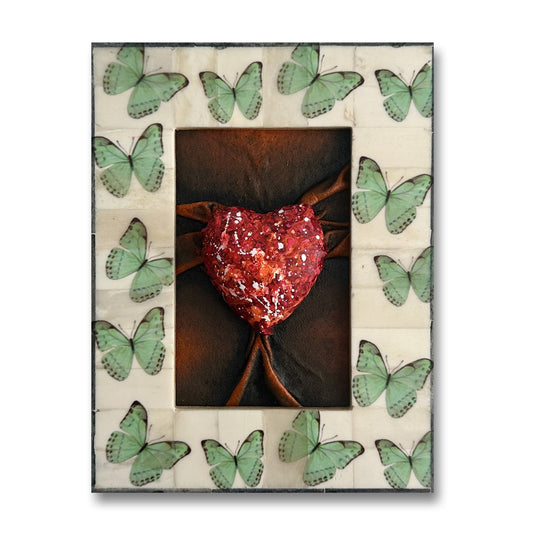 Lovers Heart Butterfly Dreams is a hand-sculpted leather art piece featuring red, black, and white splash paint for a bold, emotional statement.