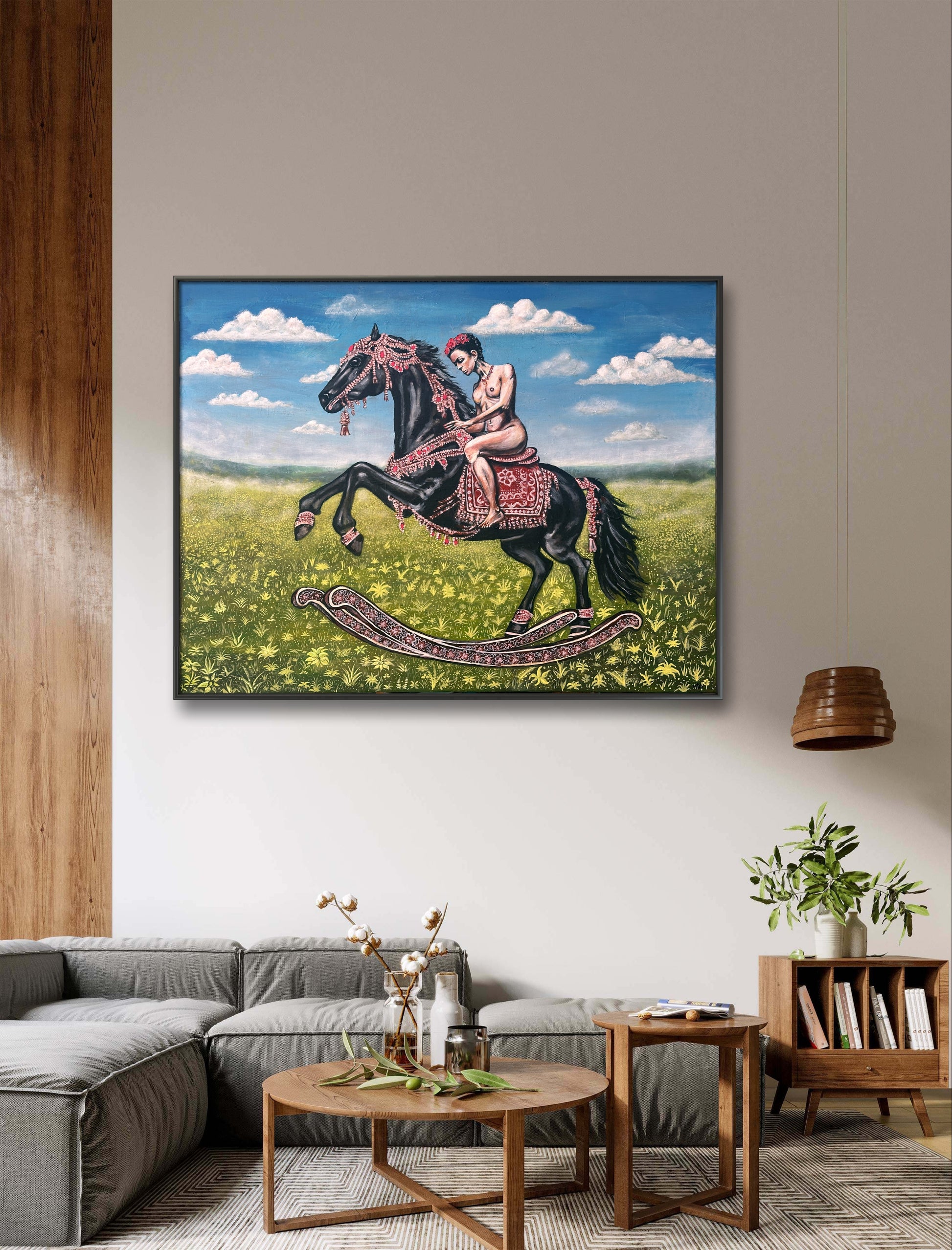 Framed artwork of a woman riding a horse in a living room setting.
