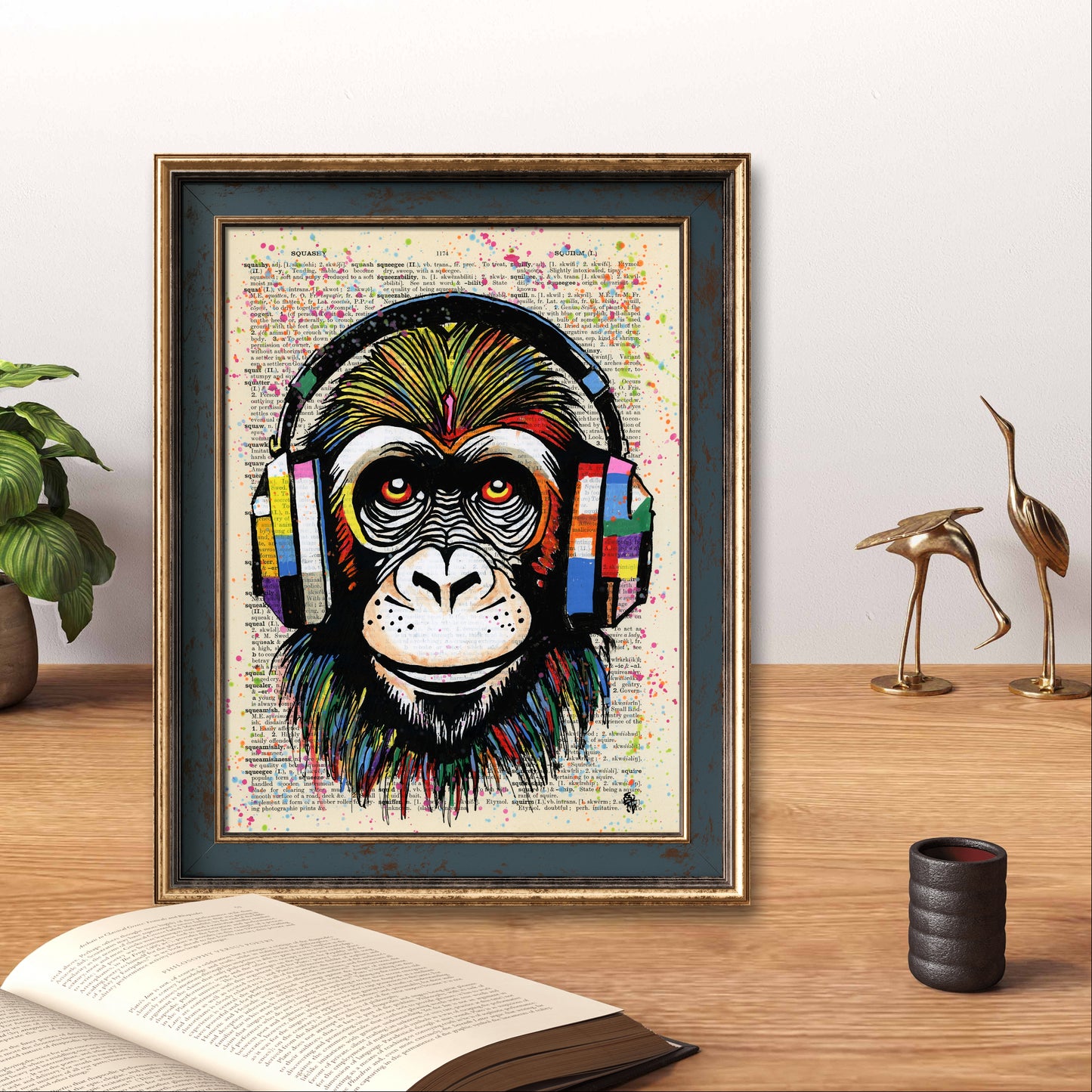 "Monkey Business" features a colorful chimpanzee with large headphones in acrylic and markers on a vintage dictionary page.