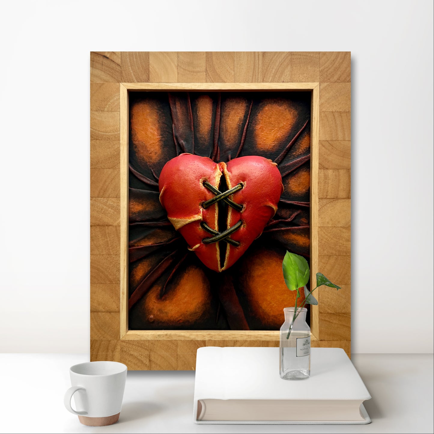 Orange and bronze heart-shaped leather sculpture by Misty Lady.