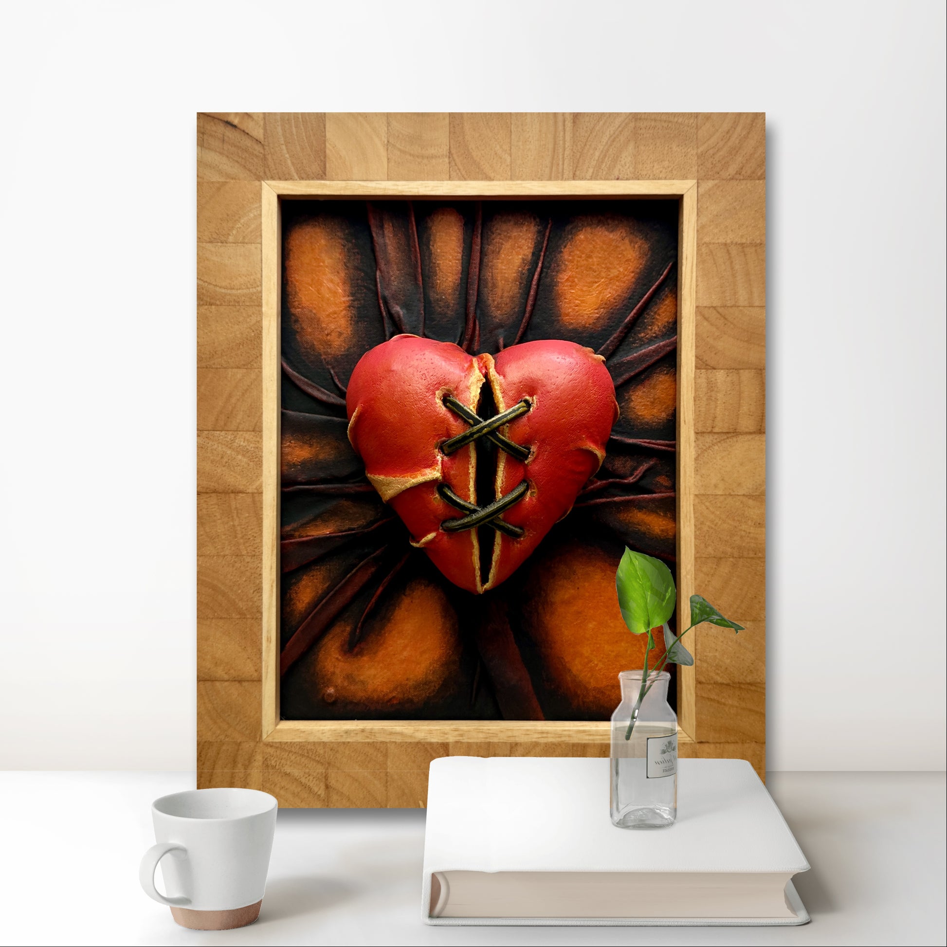 Orange and bronze heart-shaped leather sculpture by Misty Lady.