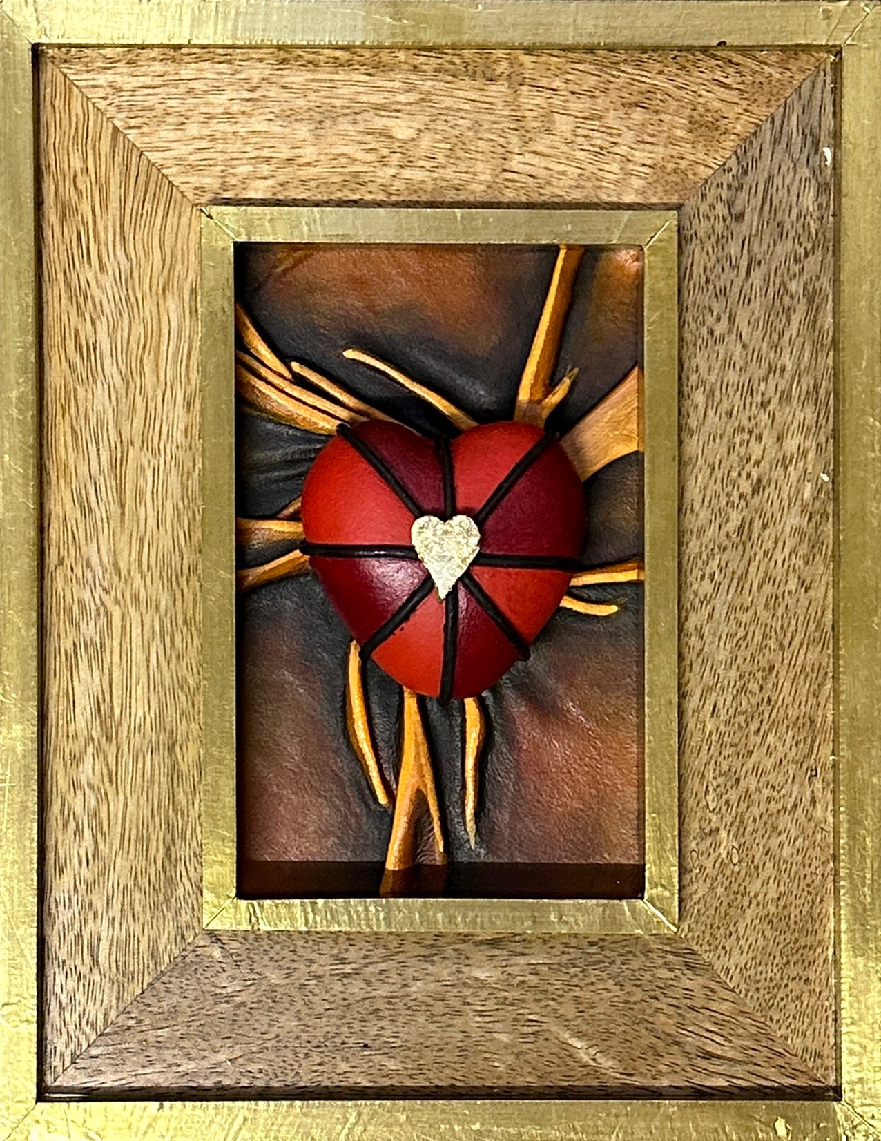 Contemporary leather heart sculpture with rich black, red, and gold accents, encased in a stunning wooden frame, signed by the artist.